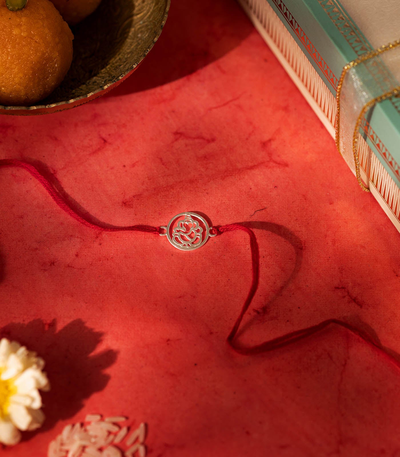 Gleaming Silver Rakhi - The Divine Ganesha Cut Out Design