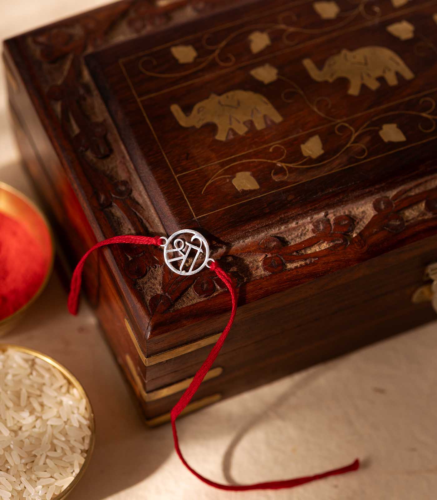 Lustrous Silver Rakhi - The Sacred "Shri" Cut Out Design
