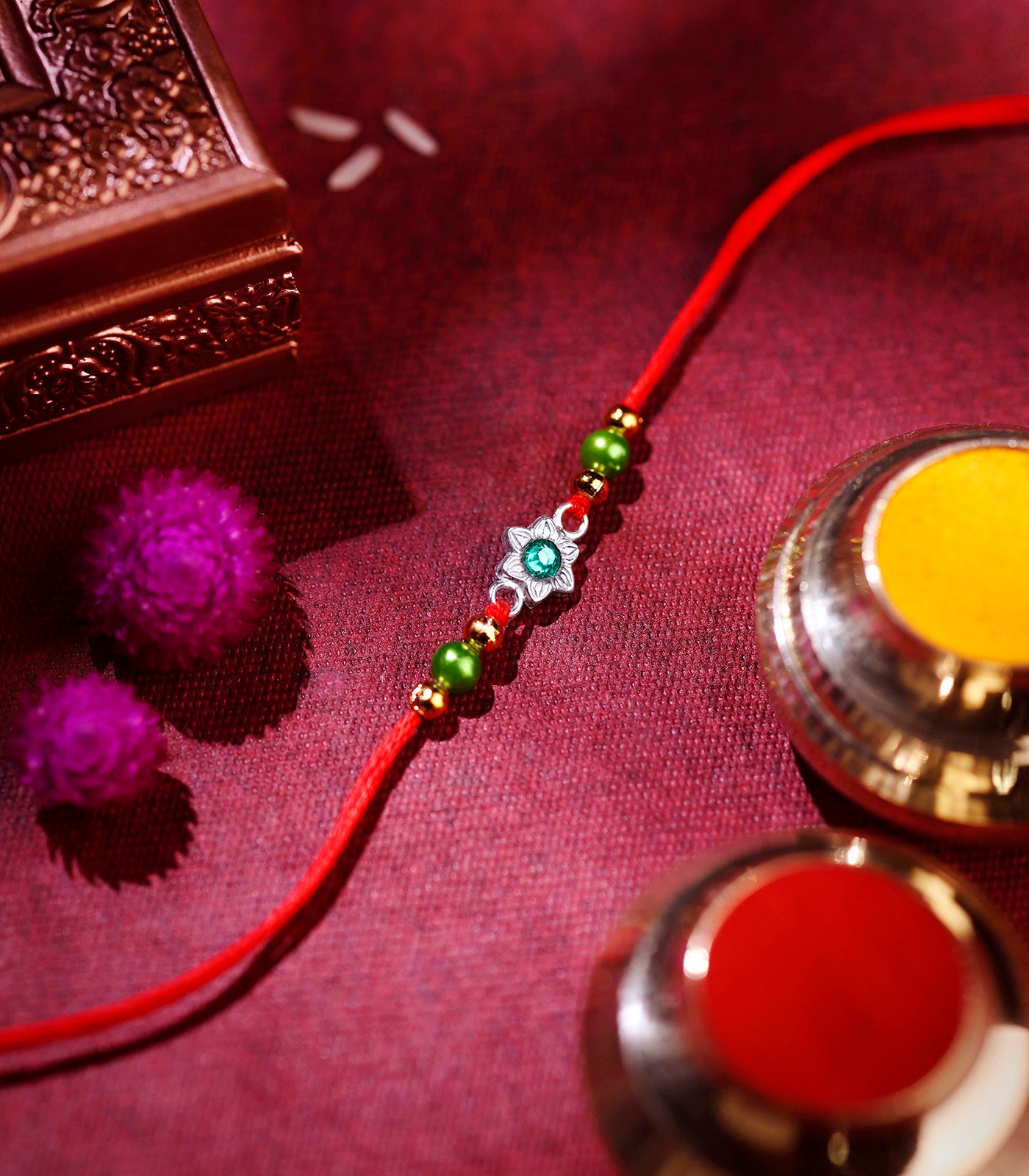 Silver Rakhi - Delicate Green Stone Floral Design