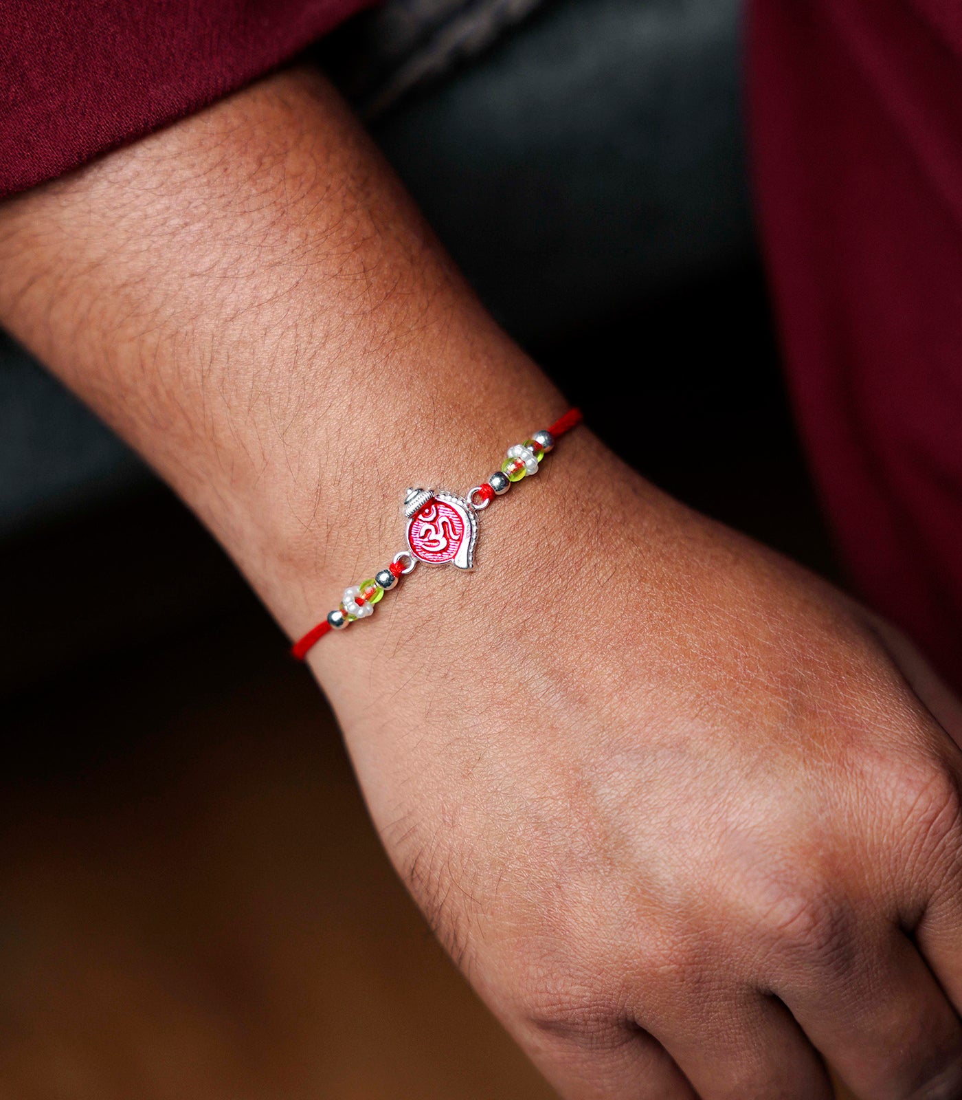 Stunning Silver Rakhi - The Elegant Om engraved Shankh Design